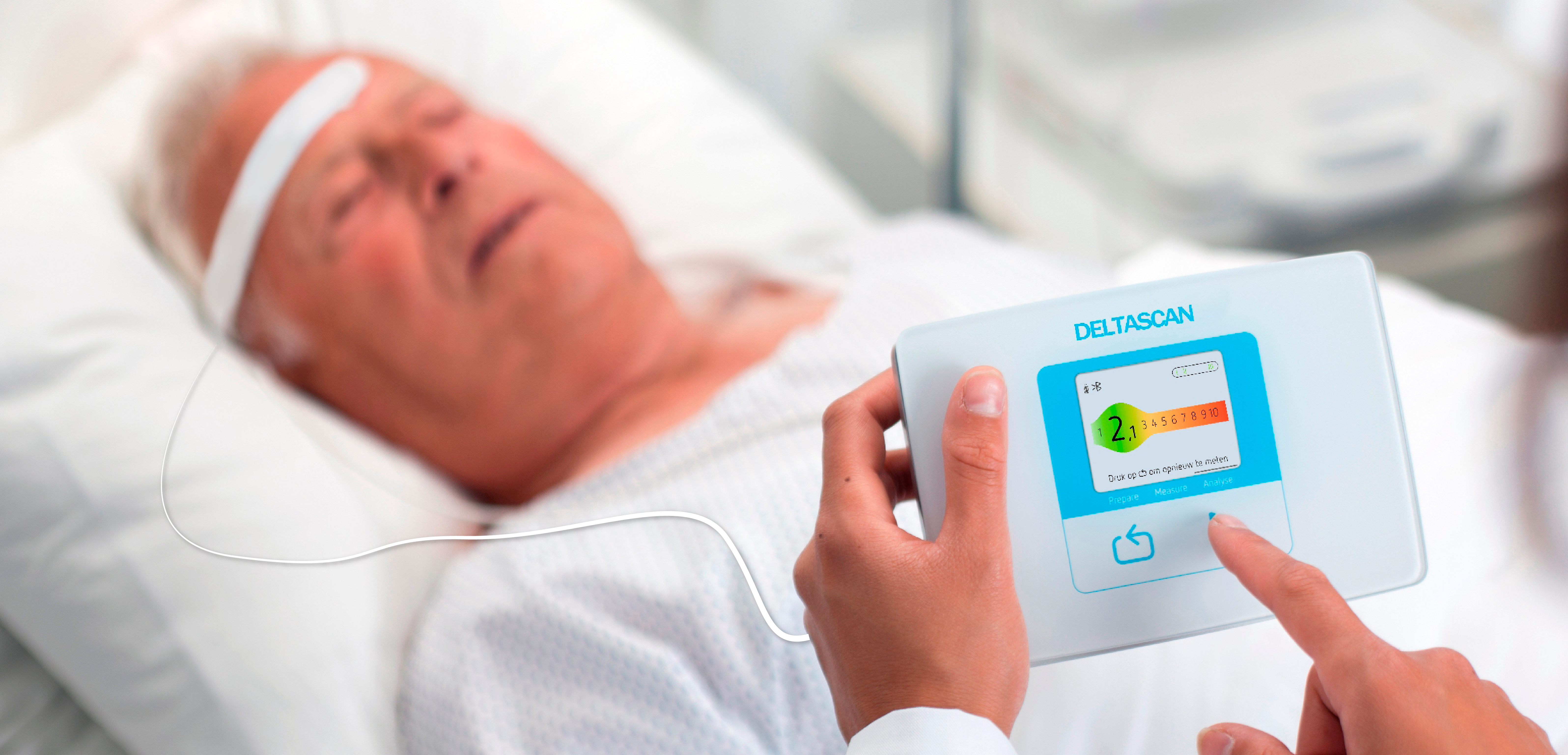 Clinician using the DeltaScan brain monitoring device at a patient's bedside